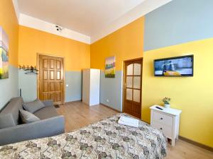 
a living room with a bed and a tv at Central Apartments Smolensk in Smolensk
