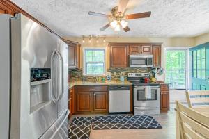 a kitchen with wooden cabinets and a ceiling fan at Lake Therapy in Mineral