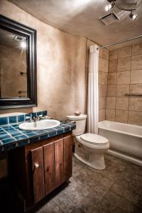 a bathroom with a sink and a toilet and a tub at Las Palomas in Santa Fe