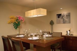 a dining room table with wine glasses and a vase of flowers at Dreams Las Mareas All Inclusive in El Jobo