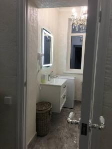 a white bathroom with a sink and a mirror at Sobor in Vinnytsya +13 photos