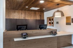 a reception desk in a dental office with wooden walls at Staybridge Suites Grand Prairie Near Epic Central, an IHG Hotel in Grand Prairie