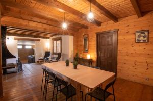 a wooden room with a table and chairs in it at Cumbres Verdes Rural in Granada