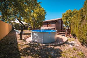 a hot tub in the yard of a house at Cumbres Verdes Rural in Granada