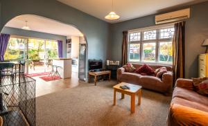 a living room with a couch and a table at 5 Amuri Avenue in Hanmer Springs