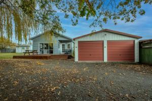 a house with a red garage at 5 Amuri Avenue in Hanmer Springs