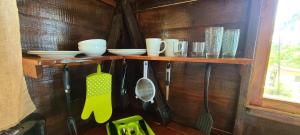 a shelf with utensils on a wooden wall at Wilton House Oceanview Cabin in Mearnsville