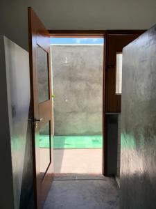 an open door to a room with a view of a pool at Quintal de Areias in Santo Amaro