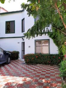 uma casa branca com um carro estacionado em frente dela em Valle lanceros Melgar em Melgar