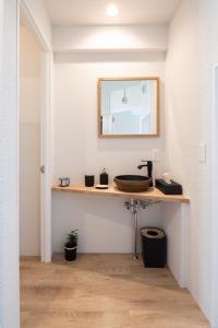 un baño con lavabo y espejo en Good Neighbors, en Kanazawa 60 fotos más