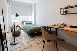 1 dormitorio con escritorio, 1 cama, escritorio y silla en Good Neighbors, en Kanazawa