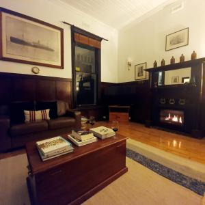 a living room with a coffee table and a fireplace at Point Lonsdale Guest House in Point Lonsdale