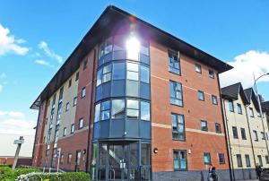 a large brick building with a large window at #4 Reed Street Apartment Hull City Centre nr Connexin Live in Hull