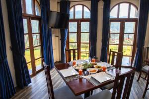 a dining room with a table with food on it at The Wind Castle in Nuwara Eliya