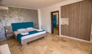 a bedroom with a bed with a blue headboard at Blue Border in Vama Veche
