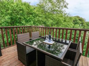an outdoor table with chairs on a deck at 19 Honicombe Park in Callington