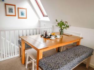 a dining room table with two chairs and a wooden table at 19 Honicombe Park in Callington