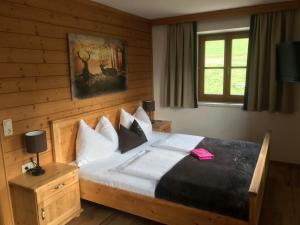 a bedroom with a bed with white pillows at Appartements Lehenhof in Sankt Johann im Pongau