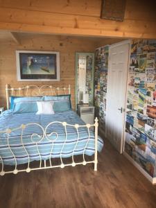 a bedroom with a large bed with a wall of pictures at SherPai Lodge with Heated outdoor Pool Pool open July to October in Kent