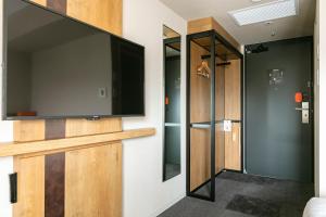 a room with a flat screen tv on a wall at Hotel Forza Osaka Namba in Osaka