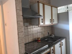 een kleine keuken met een wastafel en een magnetron bij Océano Home in Ayamonte