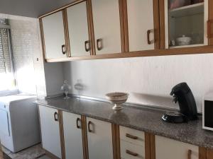 a kitchen with a counter top and a refrigerator at Océano Home in Ayamonte +20 photos