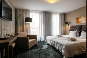 Postel nebo postele na pokoji v ubytování Johan Design & SPA Hotel