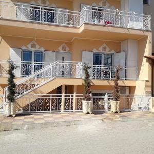 an apartment building with balconies and potted plants at HOUSE DILENA TSIMTSIRI Luxury Apartment 2 in Limenaria