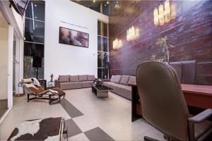 uma sala de estar com um sofá, uma mesa e cadeiras em Atrium Leisure em Boralesgamuwa