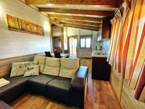 a living room with a couch and a kitchen at Bungalows Cantia in Suances
