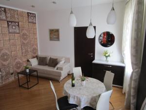 a living room with a table and a couch at Deluxe Collection Hotel Kastel - Depadanse in Split