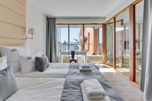 a bedroom with a large bed with a large window at Downtown Apartments Aura - Riverside & Parking in Gdańsk