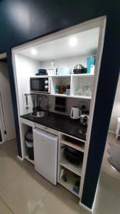a small kitchen with a counter and a microwave at Blue views at Brookes Hill Suites in Port Elizabeth