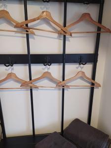 a shelf with wooden hangers in a room at Paradise in Aan de Wolfsberg