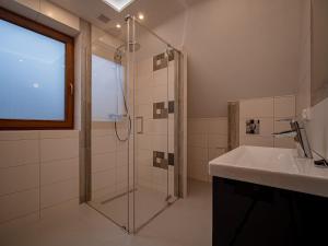 a bathroom with a shower and a sink at Tatrzańska Kryjówka Premium Chalets Zakopane in Poronin