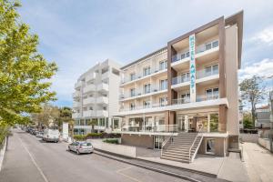 an apartment building on the corner of a street at Amalfi smart Rooms & Apartments - Ideale per Ragazzi in Riccione