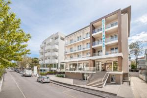 an apartment building on the corner of a street at Hotel Amalfi - Smart Hotel in Riccione