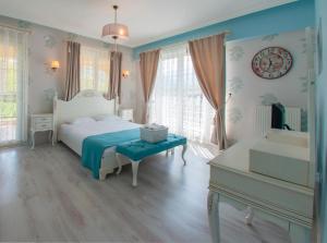 a bedroom with a white bed and a piano at Room Room Hotel in Sapanca