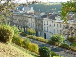 a row of white buildings on a city street at Chambres d'Hôtes Les Jardins de la Cathédrale in Angoulême