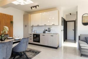 A kitchen or kitchenette at TEONA Luxury Apartment with jacuzzi and terrace sea view