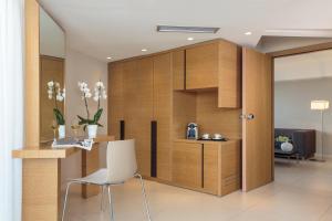 a room with a partition with a table and a chair at Cactus Hotel in Rhodes Town
