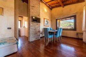 a room with a table and chairs and a bedroom at Villa Licia San Pietro in Castiadas