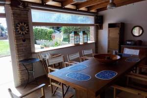 a dining room with a wooden table and chairs at The Orange Grove Garden Room in Mytikas