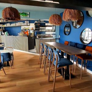 a dining room with a table and chairs at Hôtel Restaurant L'Atelier des Cousins in Châtelaillon-Plage