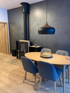 a dining room with a table and chairs and a lamp at Apartmán T5 Herlíkovice in Vrchlabí