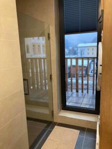 a bathroom with a window with a view of a balcony at Apartmán T5 Herlíkovice in Vrchlabí