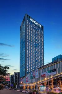a tall building with a sign on the side of it at Ascott Xiangjiang FFC Changsha in Changsha
