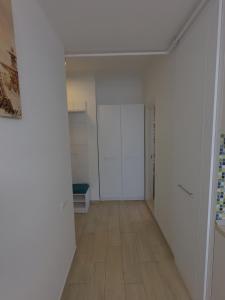an empty room with white walls and a wooden floor at Fancy Studio with Sea View in Mamaia