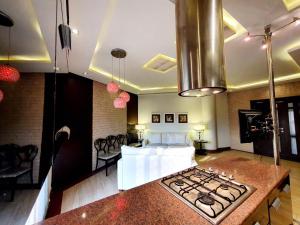 a kitchen with a stove top in a room at Luxurious Boutique One Bed Apartment In Bahria Town in Rawalpindi +8 photos