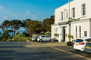 a parking lot in front of a white building at Cliffden Hotel in Teignmouth